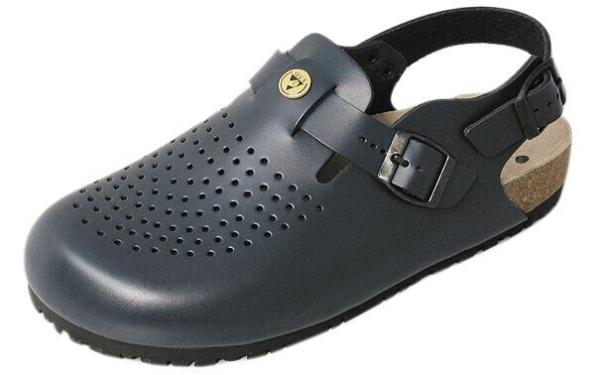 The shoe is a dark gray clog with a perforated surface for ventilation. It has an adjustable strap and a non-slip sole, ideal for comfort and stability.