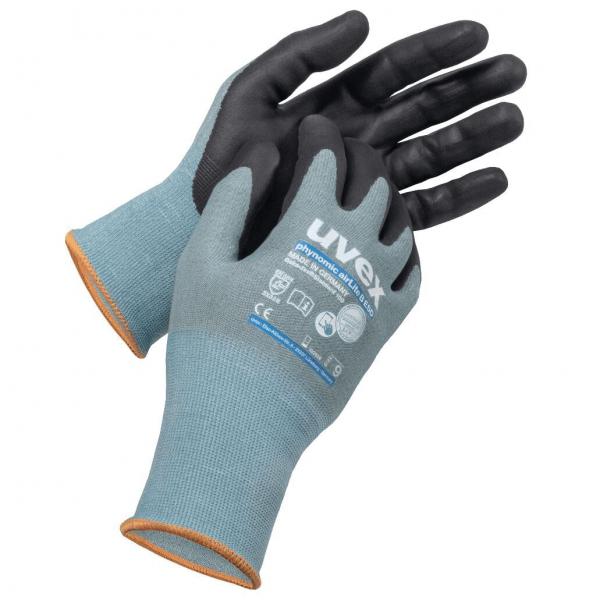 The image shows a pair of gloves. The gloves are gray with a black grip area and an orange edge on the cuff. They are designed for occupational safety.