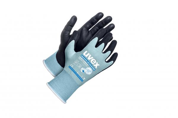 The image shows a pair of work gloves. The gloves are predominantly black, with a gray, elastic cuff at the wrist. The cuff reads "uvex".