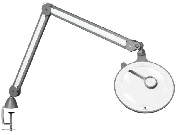 The image shows a flexible magnifying lamp with a long articulated arm. The lamp features a round, transparent lens and is attached to a sturdy clamp base.