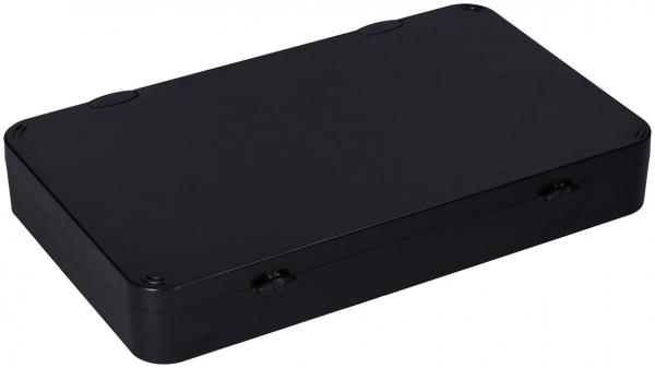 The image shows a rectangular box in black. It has a flat surface and rounded edges. The box has no visible openings or handles. It appears simple and functional.