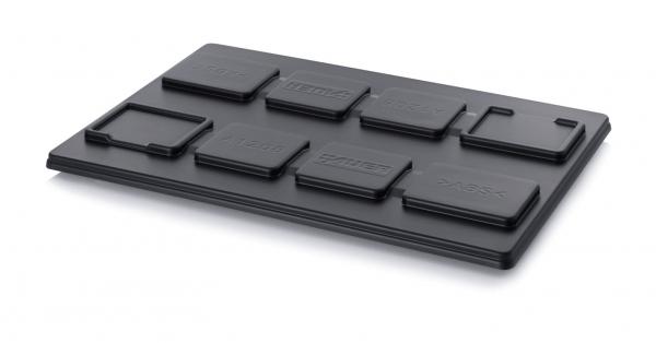 The image shows a black plastic plate with several raised rectangular and square shapes, which are labeled. The shapes are arranged differently and have various sizes.