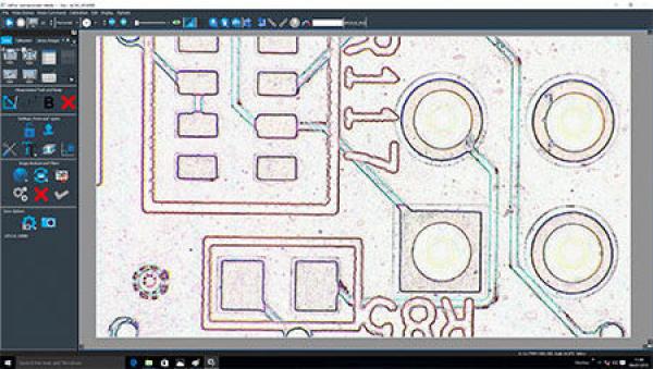 The image shows an enlarged view of a circuit board. Various electronic components and circuits are visible, including square and round formations that are interconnected.