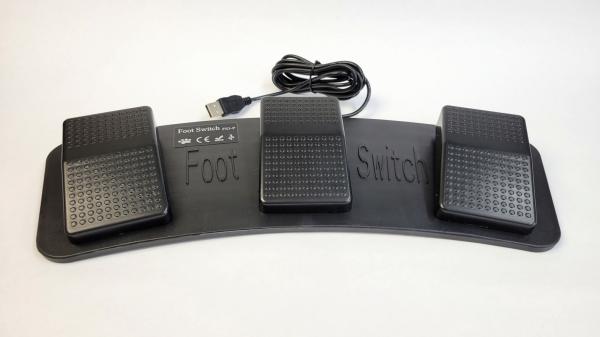 The image shows a foot switch set with three large, rectangular buttons. The buttons are black with a non-slip surface. The base reads "Foot Switch". A cable leads upwards.