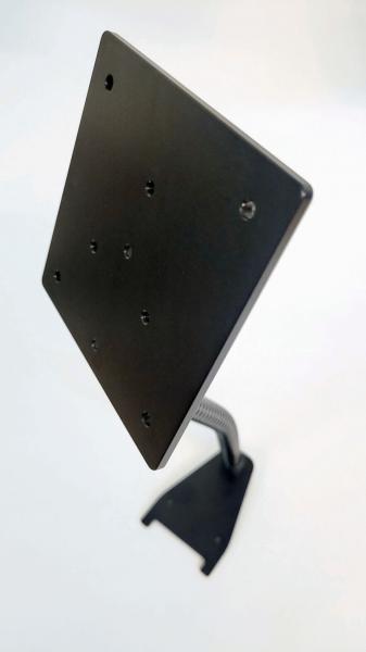 The image shows a black, rectangular bracket on a narrow base. The bracket has several holes for mounting. It is slightly tilted and appears stable.