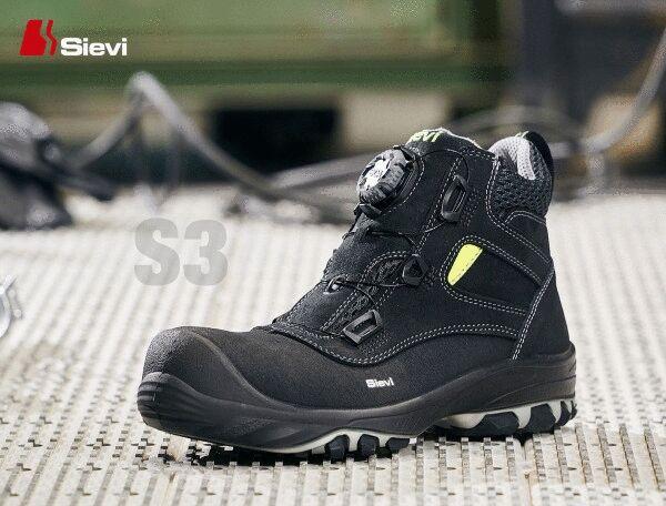 The shoe is a black safety boot with a sturdy sole. It features a practical lace-up closure with a twist mechanism and yellow accents. Ideal for occupational safety.