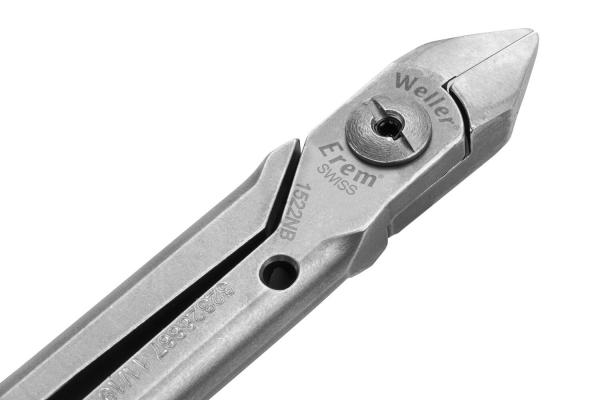 The image shows a metallic pliers with a pointed cutting edge and a polished handle. The surfaces are smooth and shiny, with embossed markings for the brand and model.
