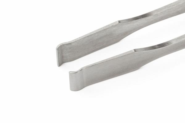The image shows a metallic tweezer with a narrow, flat shape. The ends are slightly curved and have a wide opening, ideal for grasping small objects.