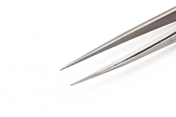 The image shows a narrow, metallic tweezer with pointed ends. The background is uniformly white, highlighting the tweezer clearly. It is long and precise.