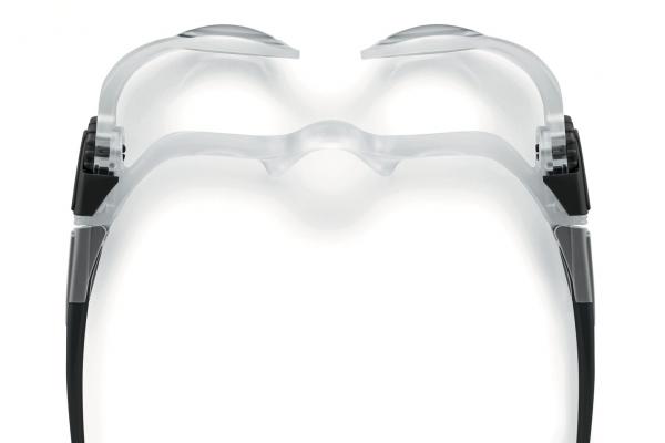 The image shows a transparent pair of glasses with a modern, minimalist design. The lenses are slightly curved and the arms are black. The shape appears futuristic and elegant.