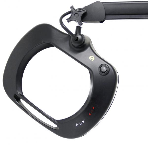 The image shows a black magnifying glass with integrated light, attached to a flexible arm. It has an oval opening and controls on the side.