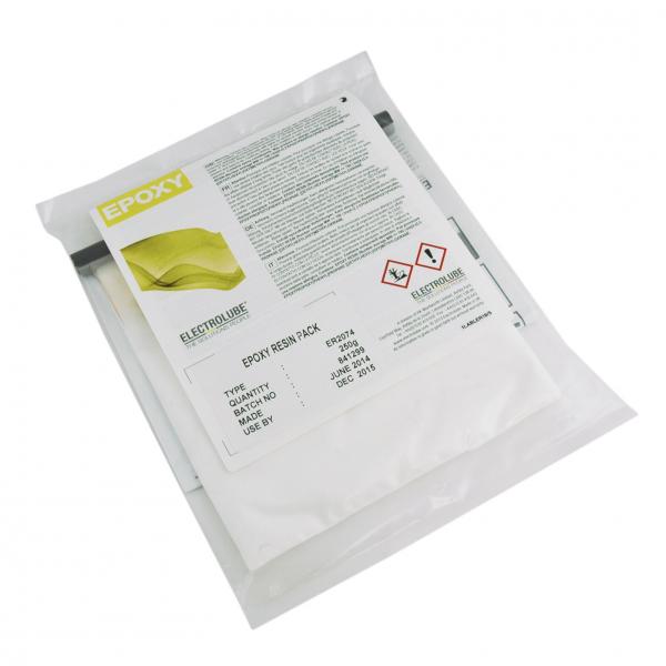Das Bild zeigt eine transparente, versiegelte Verpackung mit einem großen Etikett. Das Etikett beschreibt einen Epoxidharz und enthält Sicherheitszeichen sowie Informationen zur Anwendung.
