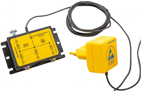 The image shows an electrical device with a rectangular, yellow casing and a connection card. A cable connects the card to a rectangular plug, which is also yellow.