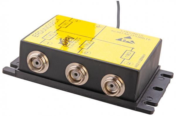 The image displays a black casing with a yellow top. It features three F-connectors and an antenna. The top includes inscriptions and symbols. The dimensions are compact and rectangular.