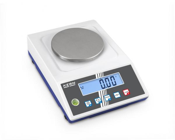The image shows a digital scale with a round, smooth metal weighing surface. Below are buttons and a blue screen that displays the weight.