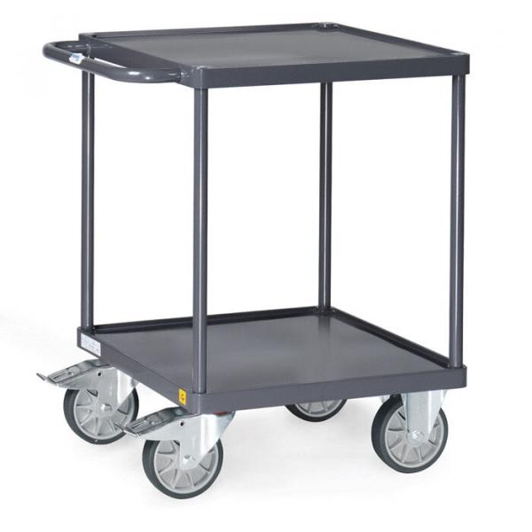The image shows a dark handcart with two shelves. It has four large, movable wheels and a handle for pushing. The structure is sturdy and practical.