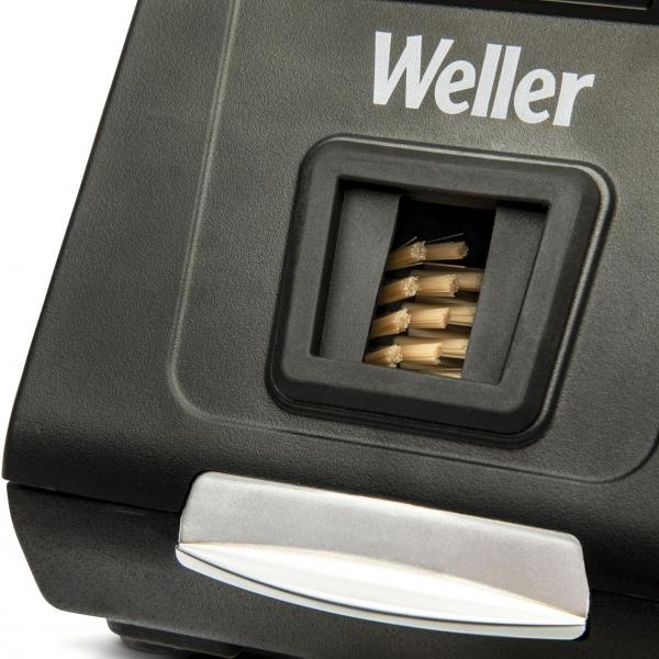 The image shows a black pen with the ?Weller? logo. At the top, there is an opening from which small metal tips are visible, and below that, a silver button.