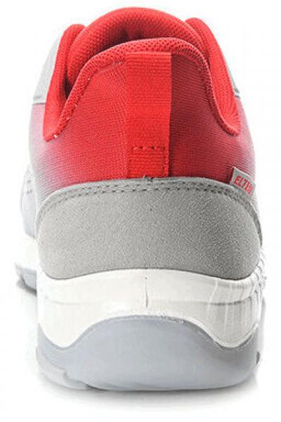 The image shows the rear view of a sports shoe. It is gray with red accents and has a light sole. The shoe has a rounded shape and appears modern and sporty.