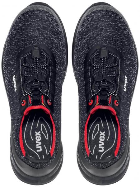 Here are two black athletic shoes with a smooth upper. They have a round toe cap, a comfortable shaft, and black laces with red accents.
