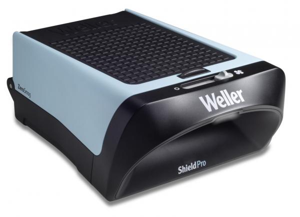 The image displays a compact, rectangular device in blue and black with a ribbed surface. It might be a soldering iron stand or a similar technology. The front has a slightly curved shape.