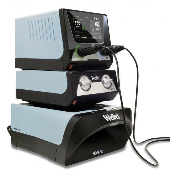 The image displays a compact, sturdy device in blue and black with digital displays on top. It features buttons and cables for electronic applications, presumably for soldering or similar tasks.