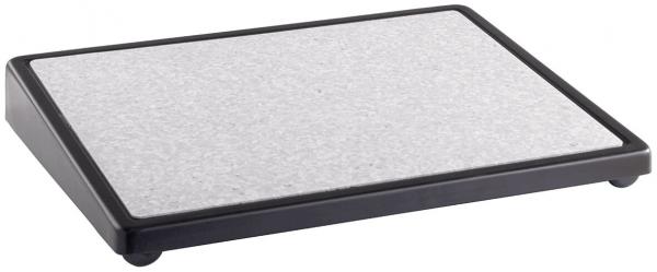 The image shows a rectangular platform with a gray, textured surface and a black frame. It has rounded corners and is supported by four small feet.