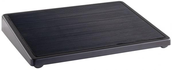 The image shows a rectangular, flat plate with a textured, matte black surface and rounded corners. It stands on four small feet.