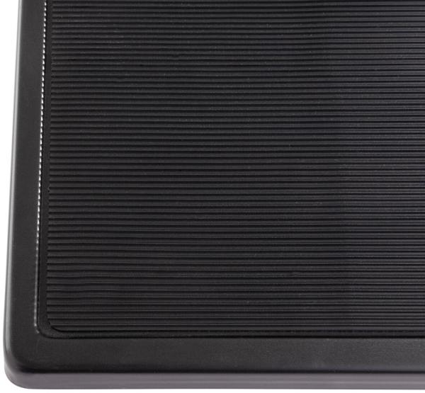 The image shows a black rubber mat with a ridged pattern. The ridges are evenly arranged and the mat has rounded corners. It is functional and durable.