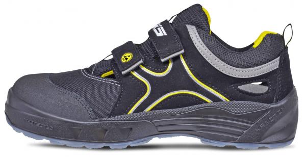 The shoe is sporty, black with yellow and gray accents. It has a wide, stable heel and a Velcro closure. The surface is made of a sturdy material.