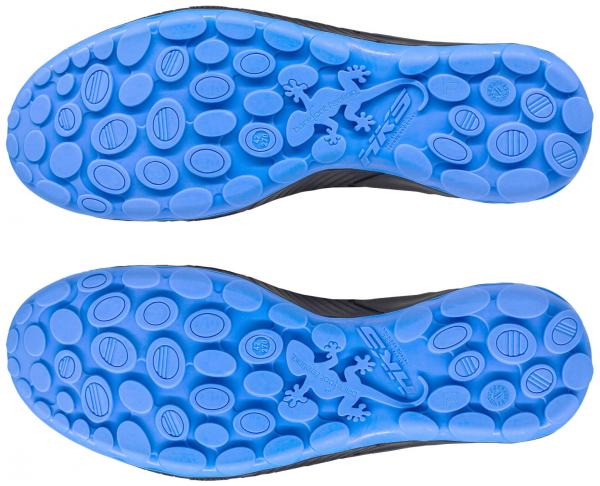 The image shows the sole of shoes with a blue rubber sole. The surface is equipped with various oval and round protrusions that provide good grip.