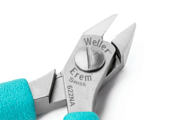 The image displays a high-quality pair of pliers with two pointed blades used for cutting. The handle is turquoise, and brand and model information are embossed on the head of the pliers.