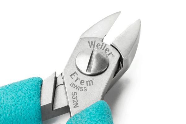 The image shows a pointed pair of pliers made of shiny metal with grippy, turquoise rubber handles. The pliers have a precise cutting edge and a rotating mechanism in the center.
