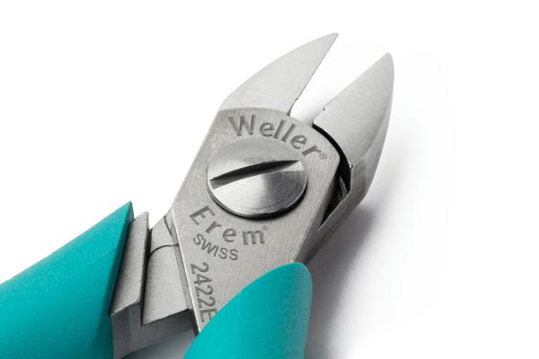 The image displays a pair of pliers with a shiny, silver blade. The handle is turquoise. The brands "Weller" and "Erem" are engraved on the pliers. It features sharp, closed edges.