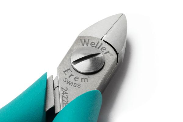 The image shows a high-quality pair of pliers with a silver, sharp head and blue, ergonomic handles. The brand "Weller" is engraved. The pliers have a precise design.