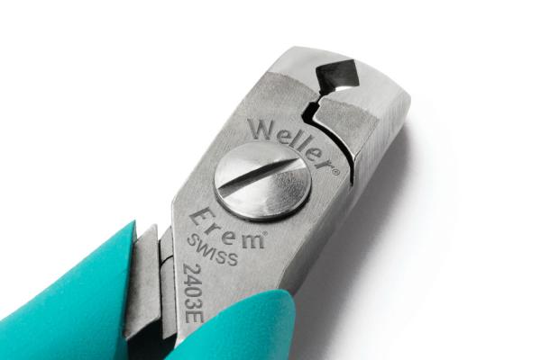 The image shows a pair of pliers with a metal head and grippy, turquoise handles. The head has a cutting edge and a central adjusting screw.