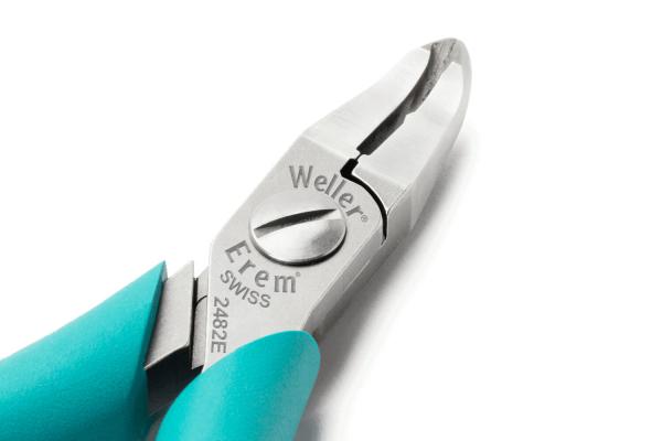 The image shows a shiny pair of pliers with narrow, pointed jaws and an elegant design. The handles are in a bold turquoise, and the surface is metallic and smooth.