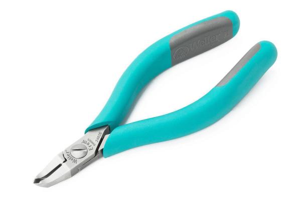 The image shows a pair of pliers with ergonomic, turquoise handles and gray rubber inserts. The blades are shiny and sharp. The pliers have a narrow, pointed shape.