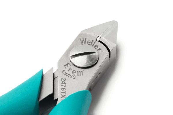 The image shows a silver pair of tongs with a pointed end and a round knob in the center. The handle is turquoise and provides a good grip.