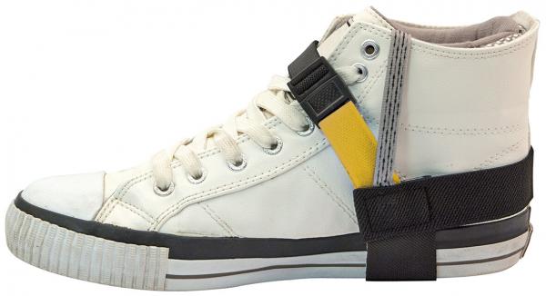 The image shows a white high-top sports shoe. It has a black sole and is secured by a black and yellow strap that wraps around the shoe.