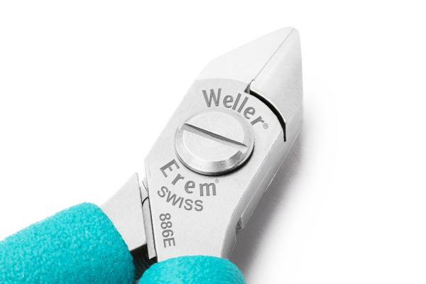 The image shows a silver, pointed pliers with a short, round handle. The handle has a turquoise rubber coating. The brand names "Weller" and "Erem" are engraved on the pliers.