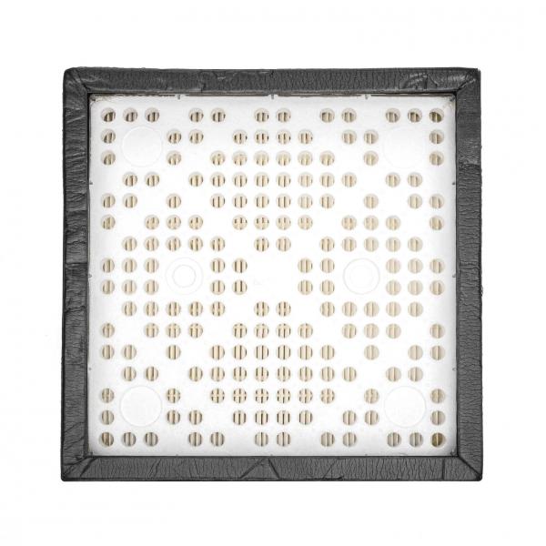 The image displays a square area with a black border. In the center, there are many small, uniform holes arranged in various patterns. It appears structured and symmetrical.