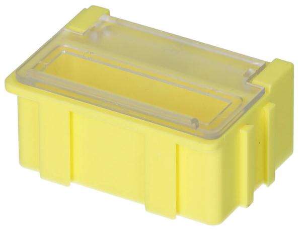 Das Bild zeigt eine kleine, gelbe Kunststoffbox mit einem durchsichtigen Deckel. Die Box hat einen rechteckigen Grundriss und seitliche Verstärkungen für Stabilität.