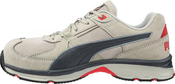 The shoe is a light, sporty sneaker. It has a light, gray upper made of textile and synthetic leather with a dark blue stripe. The sole is cushioning and has reddish accents.