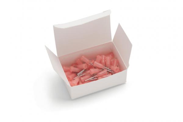 An open, white box contains several small, pink parts with metallic tips. The parts appear to be accessories or mounts, which are chaotically arranged in the box.