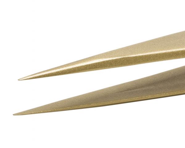 Das Bild zeigt zwei spitze, goldene Objekte, die sich berühren. Sie haben eine glatte Oberfläche und sind symmetrisch geformt, wodurch sie ein elegantes und modernes Aussehen vermitteln.