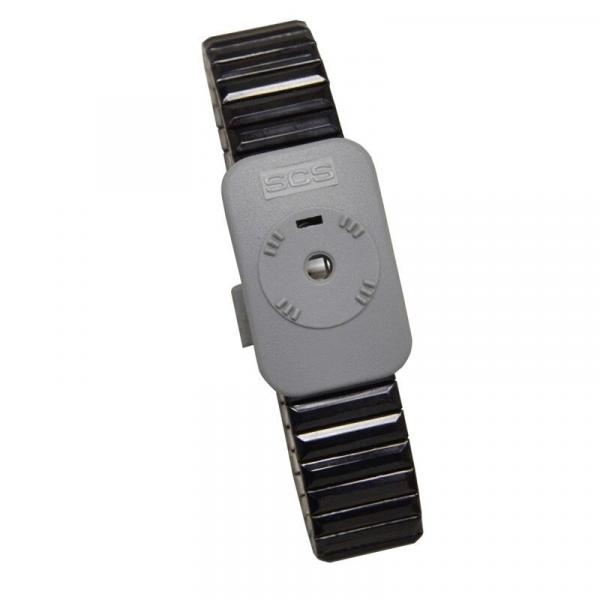 The image shows a gray bracelet with a wide, flexible band. In the center, there is a rectangular case featuring a round, raised button and simple markings.