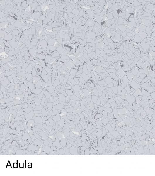 The image shows a bright, gray surface made up of many small, irregular, and shiny particles. These are arranged in various shades of gray. Below it reads "Adula".