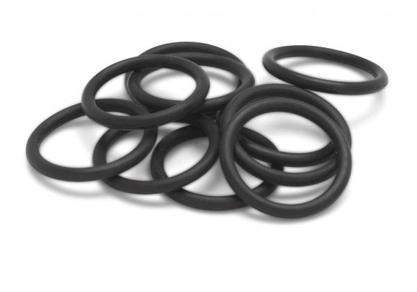 The image shows several black rubber rings stacked on top of each other. The rings have a smooth, round shape and vary slightly in position.