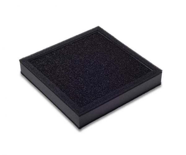 The image shows a square, flat object in black with a rough, textured surface. It has a matte finish and looks like a cushion or pad.