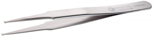 The image shows a metallic tweezer with narrow, pointed tips. It is shiny and has an elongated shape that narrows in the middle. The tips are slightly curved.